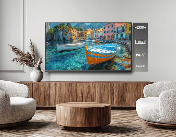 TV on a timber sideboard in a light lounge room, with HDMI, USB, Wi-Fi and Bluetooth labelled beside it