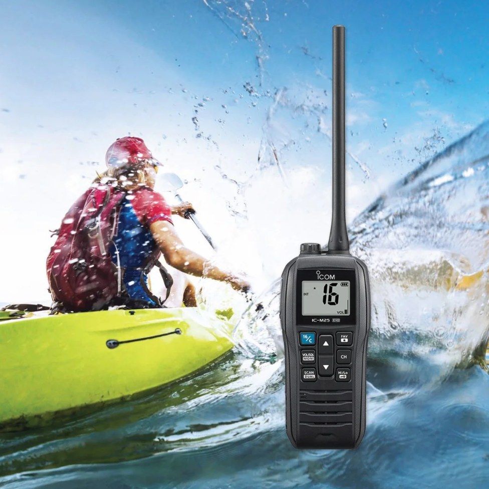 A kayaker holding an iCOM floating marine VHF handheld