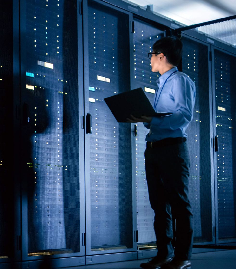 An engineer working at a rack in a data room